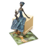 Afrikansk blå kvinde sidder med baby fair trade figur som gave til mor