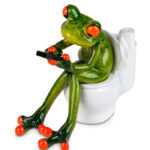 Frø på toilettet med mobiltelefon